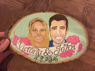 A painted portrait of a couple on a wood block as a wedding gift, created with ink and acrylic paint.